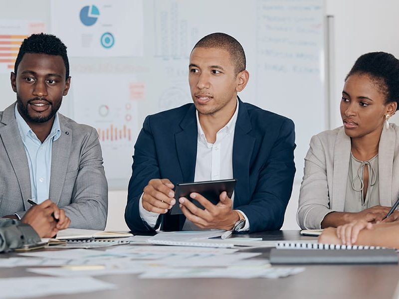 leadership-planning-talking-about-ideas-with-marketing-advertising-finance-team-using-tablet-corporate-office-business-people-together-collaboration-teamwork-project-management